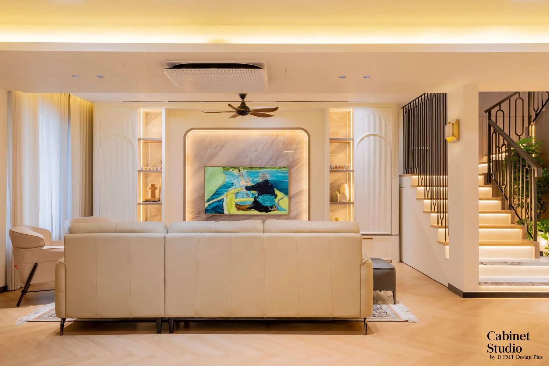 Open-plan living room with a feature wall and cabinetry beside the staircase — Cabinet Studio