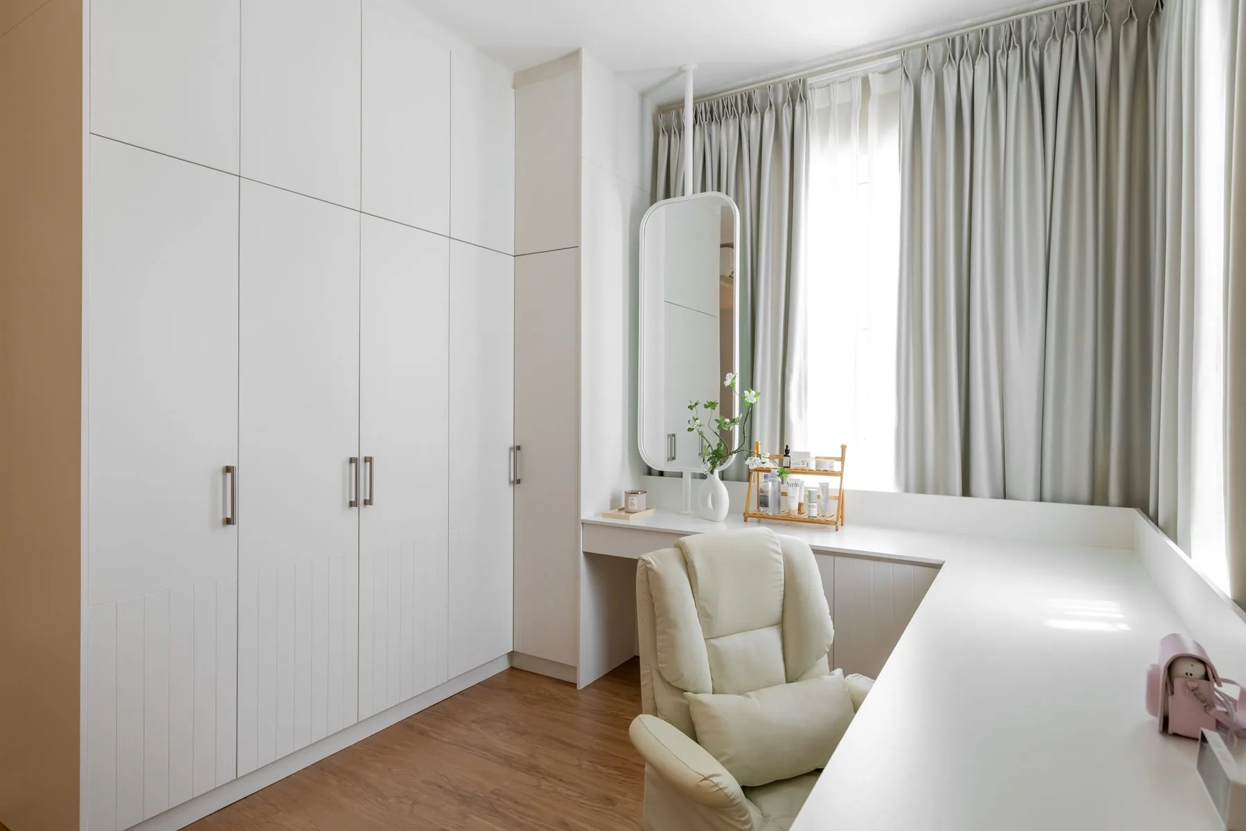 Bedroom with a white built-in wardrobe and a dressing table by the window — Cabinet Studio