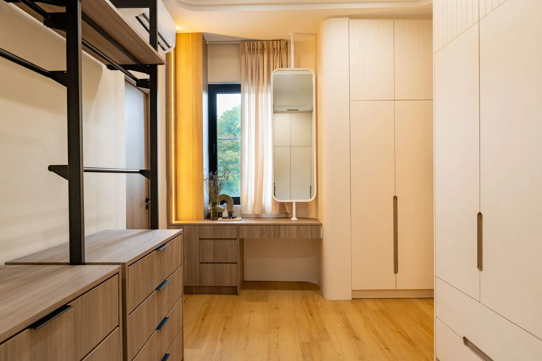 Walk-in wardrobe with open hanging rails, drawer units and a mirror — Cabinet Studio